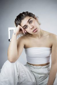 Press shot of Ashley Leone sitting on a chair