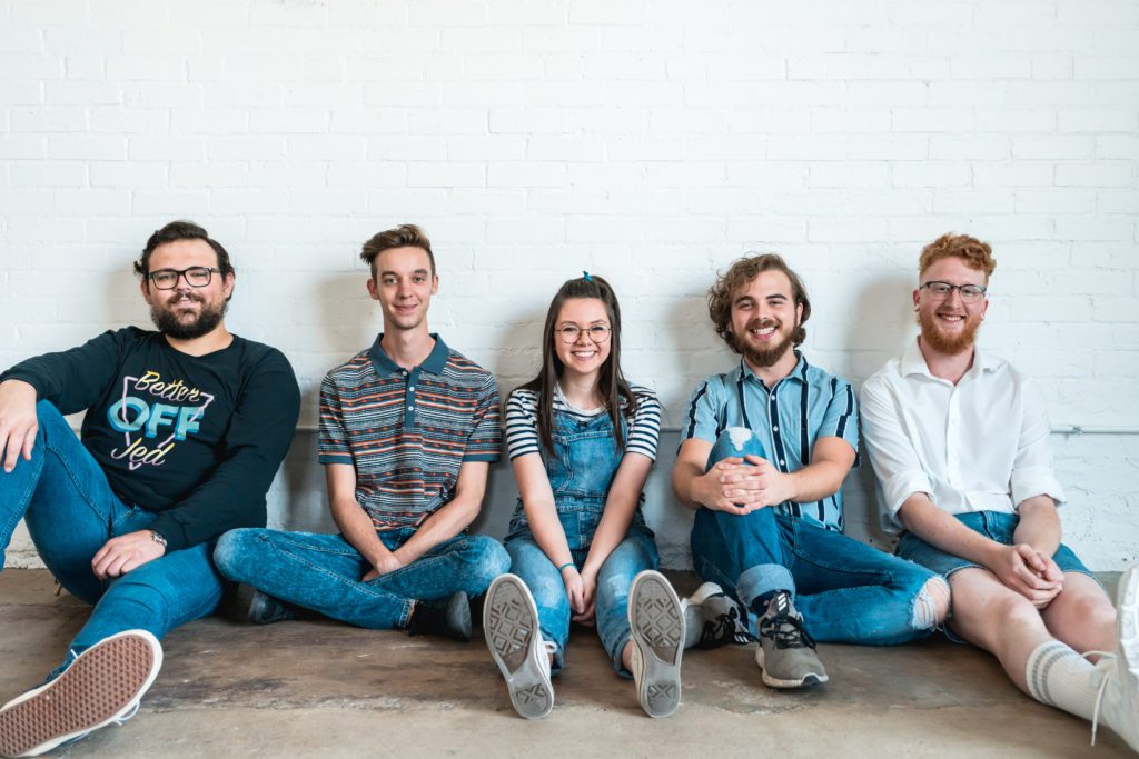 Vasco band press image band sitting down and smiling