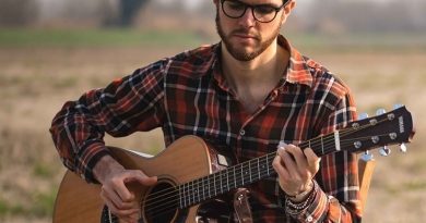 James Meadow singing with guitar