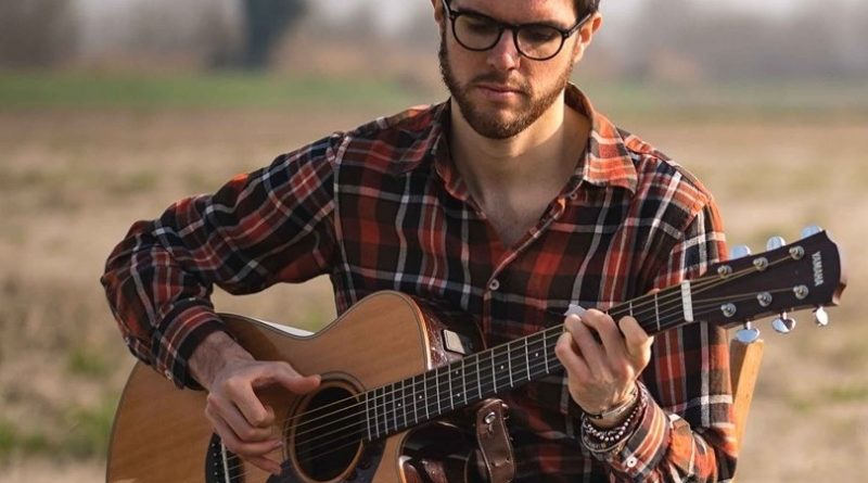 James Meadow singing with guitar