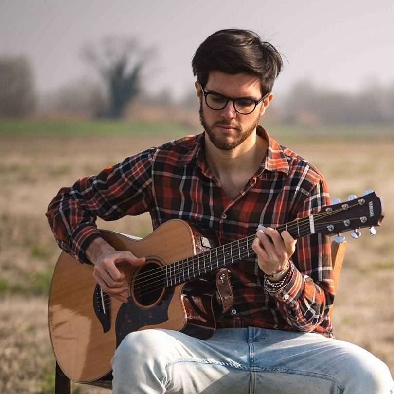 James Meadow singing with guitar